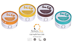 Vier Teedosen der Herbal Twist Collection: Ginger Zest, Lemon Harmony, Roiboos Cacao Chai und Peppermint Delight in Aufsicht